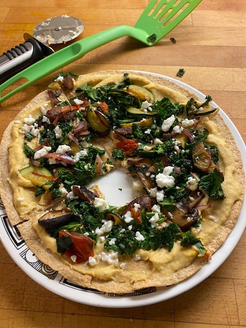 a easy to make pizza using hummus and cooked veggies