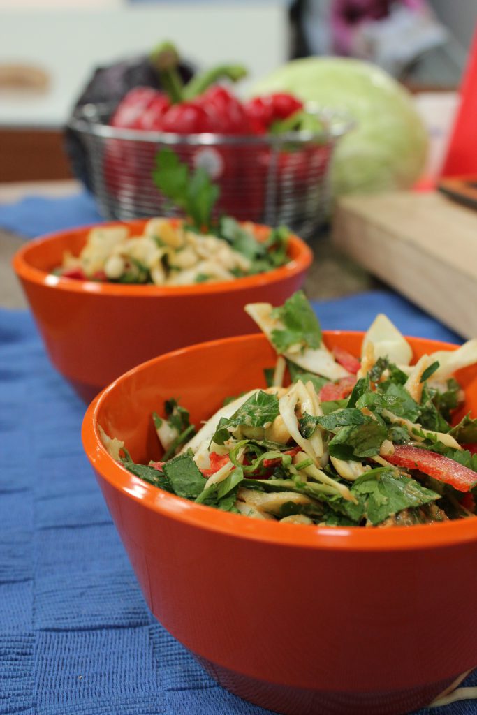 main course vegetarain salad with peanuts in an orange bowl